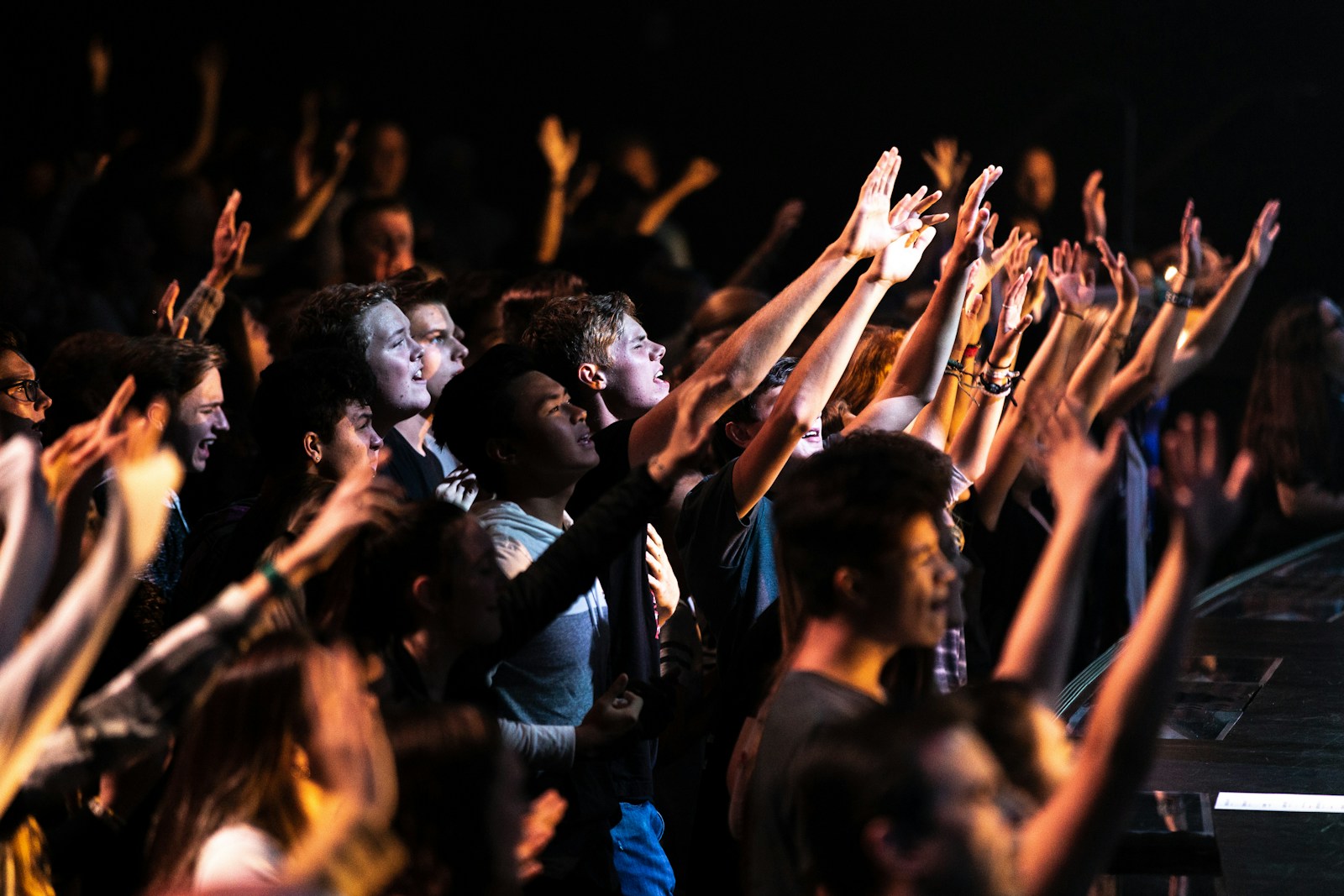 Adonai lyrics - people raising hands in worship at night