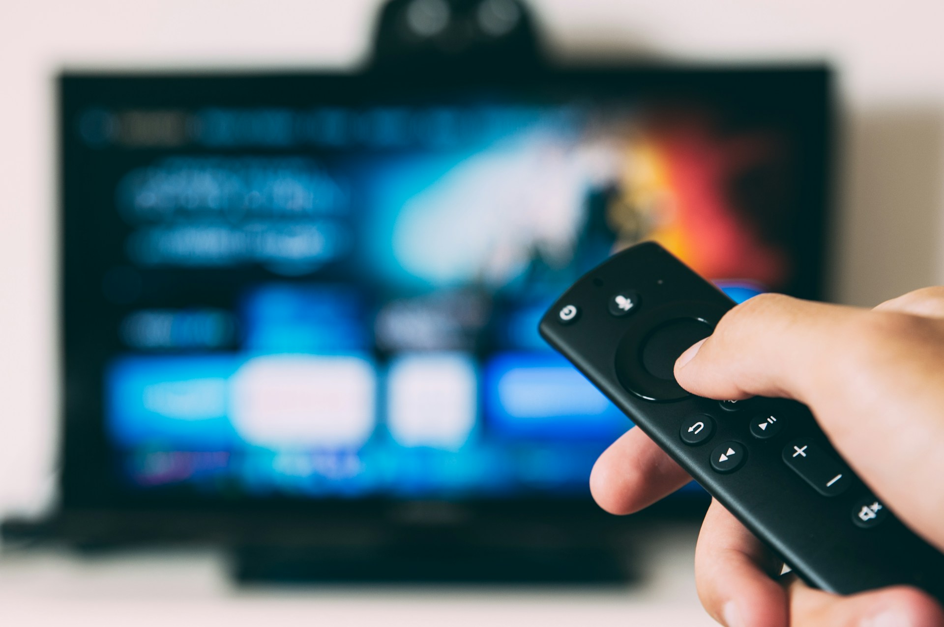 Smart TV with remote control representing display trends in consumer electronics news today