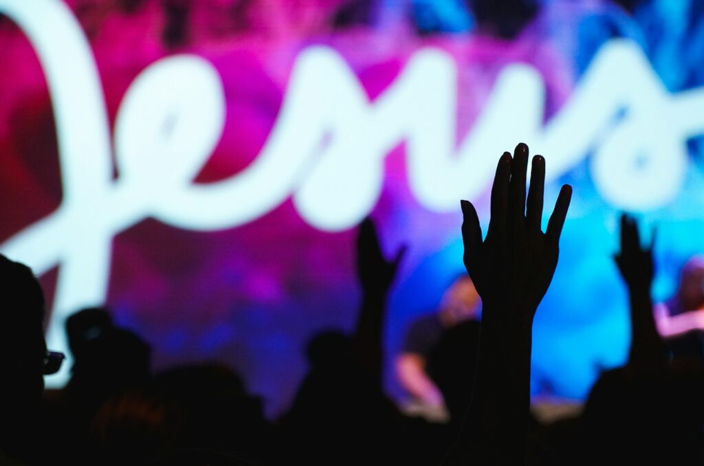New Thing Coming lyrics - silhouettes of raised hands in worship